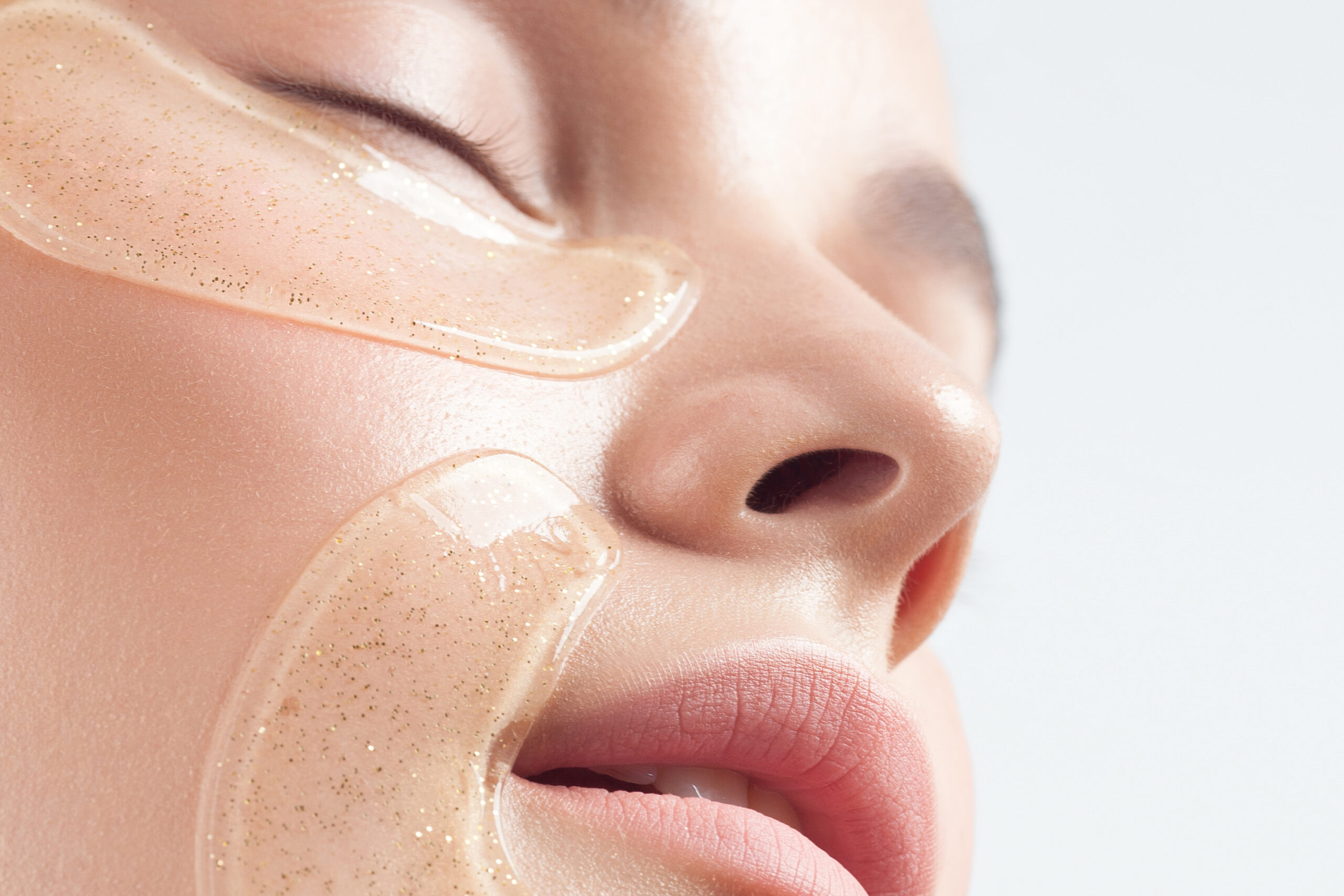 Close-up of young caucasian female with glittering face masks for skincare.
